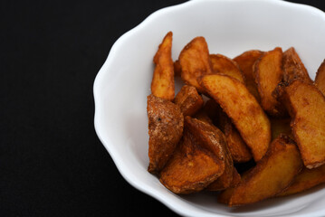 Rustic potatoes in a plate. Delicious fried potatoes.