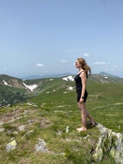 woman on the rocks in mountains