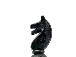 Old black chess piece horse isolated on white background