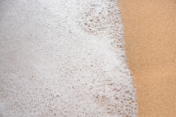 Sea foam on the sand. Summer background 