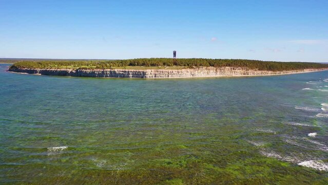 4K panoramic aerial video from flying drone to Panga coastal cliff and lighthouse , northern shore of Saaremaa island, near Kuressaare, Baltic Klint.Saaremaa , Estonia