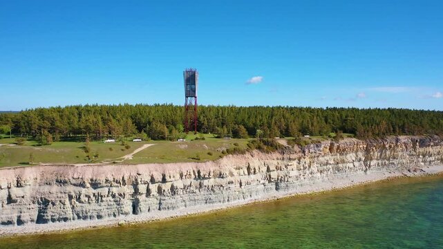 4K panoramic aerial video from flying drone to Panga coastal cliff and lighthouse , northern shore of Saaremaa island, near Kuressaare, Baltic Klint.Saaremaa , Estonia