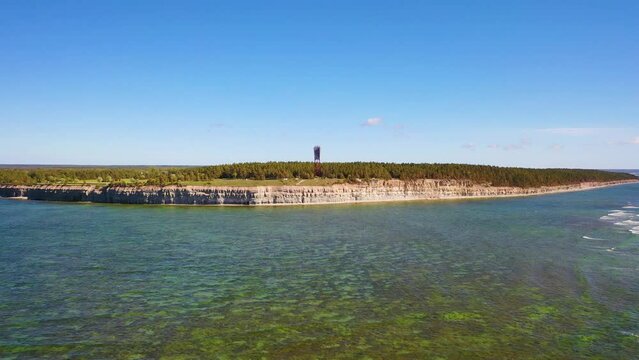4K panoramic aerial video from flying drone to Panga coastal cliff and lighthouse , northern shore of Saaremaa island, near Kuressaare, Baltic Klint.Saaremaa , Estonia