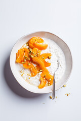 Breakfast cottage cheese with apricot, maple syrup and pistachio.