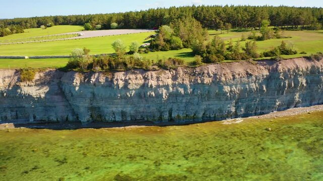 4K panoramic aerial video from flying drone to Panga coastal cliff and lighthouse , northern shore of Saaremaa island, near Kuressaare, Baltic Klint.Saaremaa , Estonia