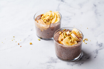 Chocolate chia pudding with banana, pistachio and maple syrup.