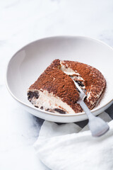 Portion of homemade tiramisu with chocolate cookies.