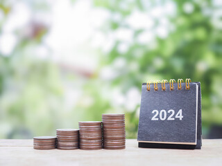 2024 desk calendar and stack of coins. The concept of business growth, Financial investment, Market...