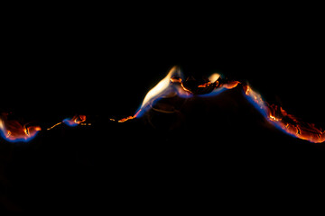 burning paper, glowing edge of paper on a black background.