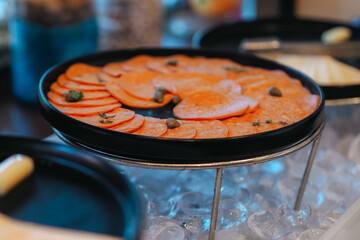plate with slices of pastrami, dried beef meat seasoned with herbs,