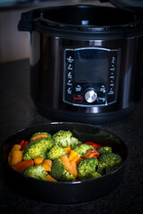 fresh cooking at home - colorful vegetable cooked in a pressure cooker