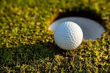 Closeup Golf ball on green grass on course