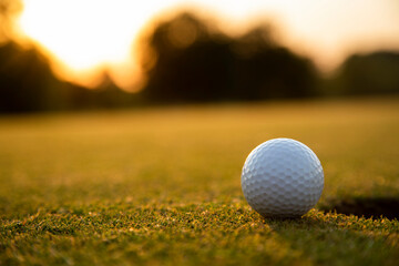 Closeup Golf ball on green grass on course, Sport and lifestyle