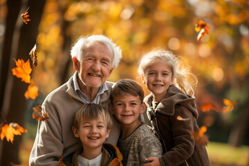 Fototapeta premium Grandfather happily embracing three grandchildren during autumn, surrounded by falling leaves, showcasing family bonding and love
