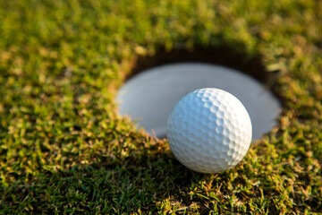 Closeup Golf ball on green grass on course