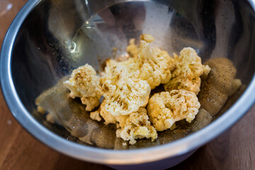 Chef at the kitchen preparing bean porridge with cauliflower and vegetables