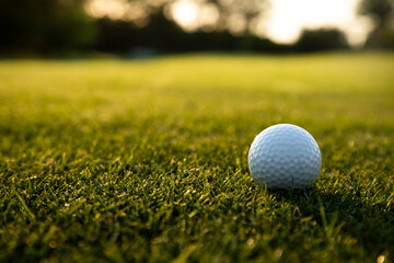 Golf ball and clubs in golf field