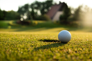 Closeup Golf ball on green grass on course