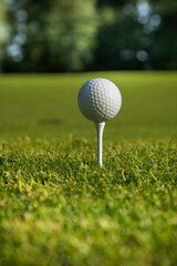 Golf ball and clubs in golf field