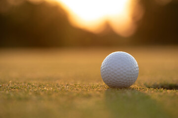 Golf ball and clubs in golf field