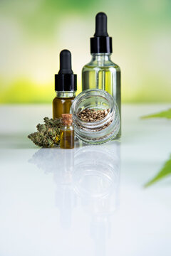 Bottles of cbd oil, marijuana and hemp leaves