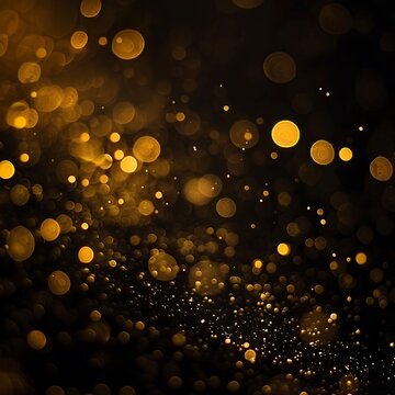 Golden sparky glitter bokeh lights on black background