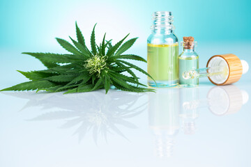 Fototapeta premium Bottles of cbd oil, marijuana and hemp leaves