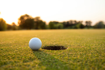 Golf ball and clubs in golf field