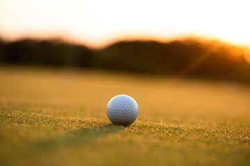 Closeup Golf ball on green grass on course, Sport and lifestyle