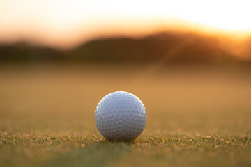 Golf ball and clubs in golf field