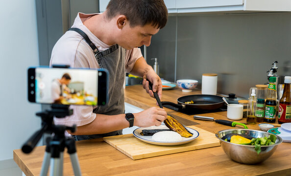 The chef is broadcasting live from workshop how to prepare a grilled eggplants with garlic