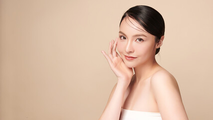 Beautiful young asian woman with clean fresh skin on beige background, Face care, Facial treatment, Cosmetology, beauty and spa, Asian women portrait.