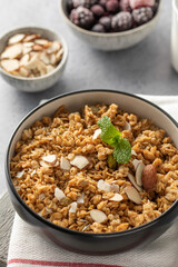 Crispy homemade granola with sliced almonds in a bowl. Healthy food