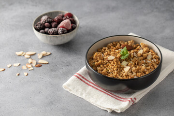 Crispy homemade granola with sliced almonds in a bowl. Healthy food
