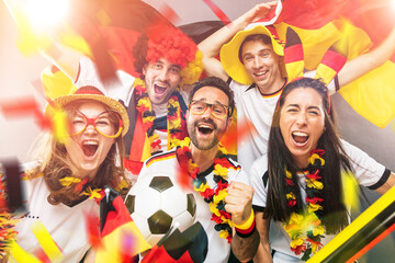 Group of enthusiastic German soccer fans celebrating the victory