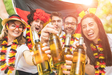 Group of enthusiastic German soccer fans celebrating the victory