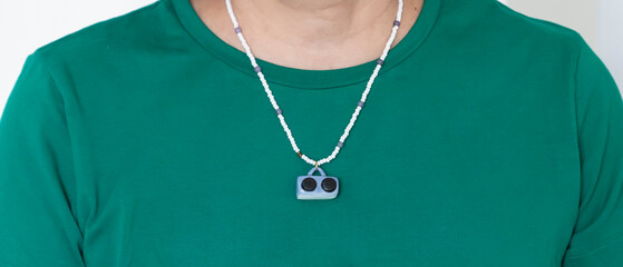 Creative beaded necklace and miniature ceramic pendant in the form of a tape recorder