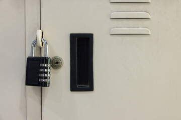 A metal locker with a padlock on it