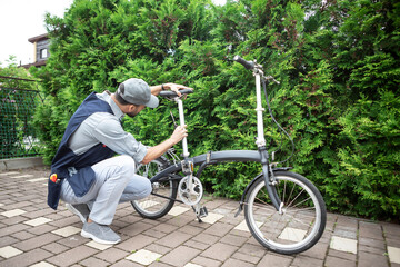 Close-up shot of repairman fixing bicycle	