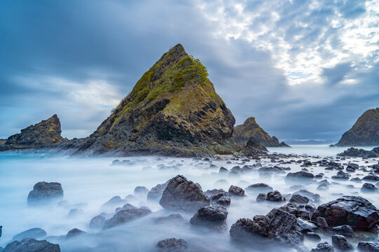 dramatic coastal scene  with rocky cliffs and waves