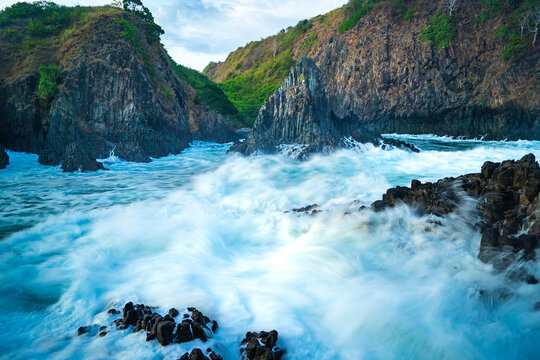 dramatic coastal scene  with rocky cliffs and waves