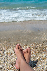 Woman’s feet on the beach