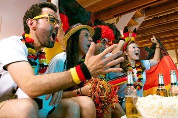 Group of enthusiastic German soccer fans celebrating the victory