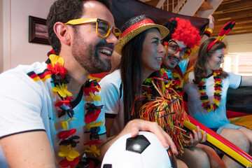 Group of enthusiastic German soccer fans celebrating the victory