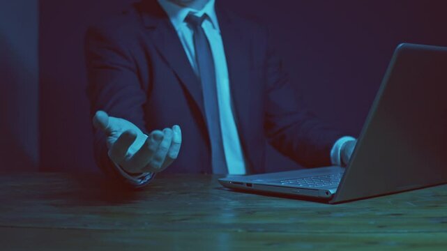 A businessman working on a laptop with one hand demonstrates the capabilities of new technologies in a presentation. A tree grows above the palm with fruits containing various thematic symbols. Cg