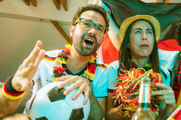 Group of enthusiastic German soccer fans celebrating the victory