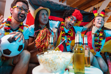 Group of enthusiastic German soccer fans celebrating the victory