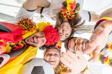 Group of enthusiastic German soccer fans celebrating the victory