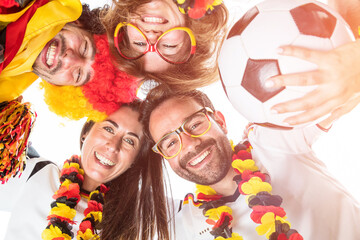 Group of enthusiastic German soccer fans celebrating the victory