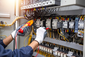 Electricity and electrical maintenance service, Engineer hand holding AC voltmeter checking...